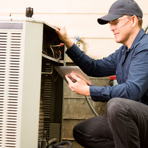 HVAC technician working on ac unit