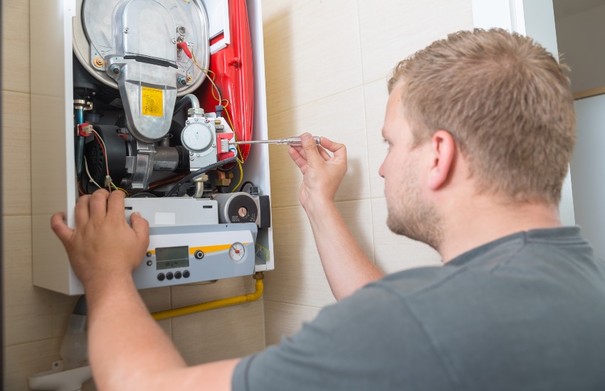 Technician Repairing Gas Furnace in Portland, OR